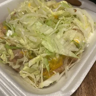 Yellow shredded cheese on sopes...