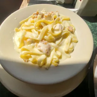 a plate of pasta and a hot dog