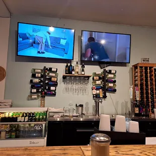 a bar with two televisions on the wall