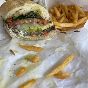 Veggie sub with pesto, goer cheese, spinach mushrooms tomatoes sprouts zucchini and bacon with vedalia onion vinaigrette and Dijon mustard