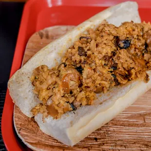 a sub sandwich on a wooden tray