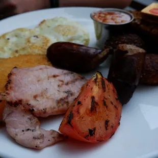 THE PROPER FULL IRISH BREAKFAST Irish sausages, Black and white pudding, Irish bacon, eggs, grilled tomatoes, Heinz baked beans, Irish soda