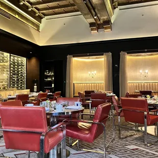 a dining room with red leather chairs