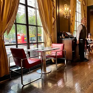 a man standing at the front desk of a restaurant