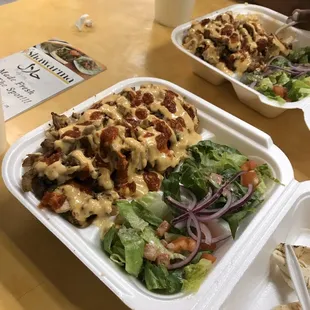 two takeout containers of food on a table