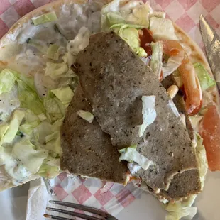 Opened up. Only a few pieces of meat, tons of sauce and crappy iceberg on dry pita.
