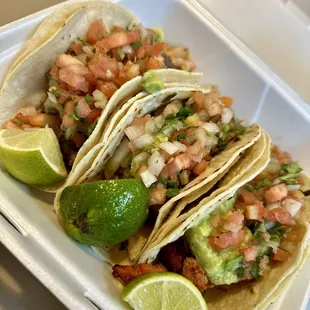 three tacos in a styrofoam container