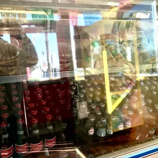A big fridge inside Cold Glass Soda Bottles