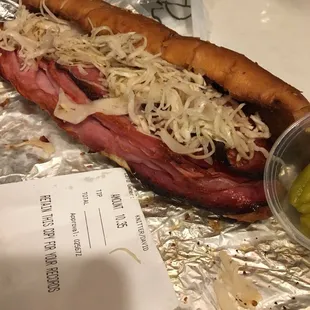 a hot dog with sauerkraut and pickles
