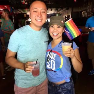 a man and a woman holding drinks