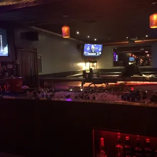 a bar with a lot of bottles of alcohol