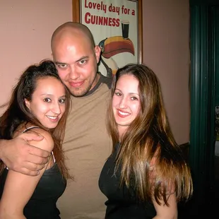  man hugging two women
