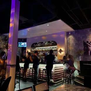 a group of people sitting at a bar