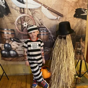 a little boy dressed as a prisoner