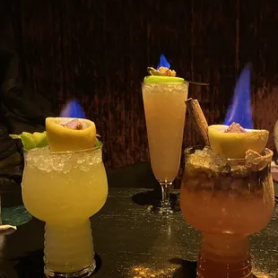 three different cocktails on a table