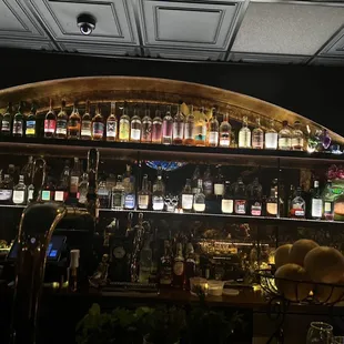 a bar with shelves full of liquor bottles