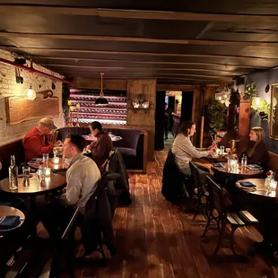 people sitting at tables in a restaurant
