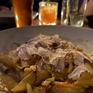 a plate of pasta with parmesan cheese