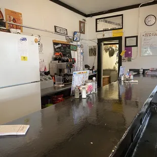 a kitchen counter with a refrigerator