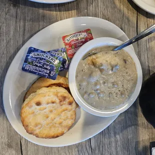 Side of sausage gravy and a side of biscuits.