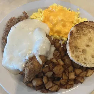 Fried chicken steak w/ gravy, hash browns, English muffin and eggs!