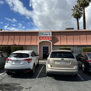 two cars parked in front of the restaurant