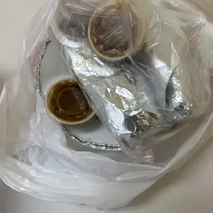 a plate of food wrapped in plastic