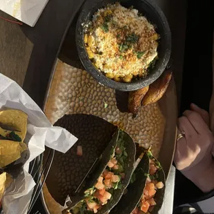 Traditional steak tacos and street corn.