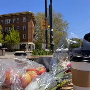 a cup of coffee and a bunch of fruit