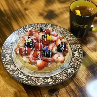 Waffle topped with berries and syrup sahlep