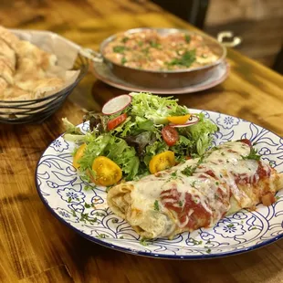 Rolled crepe stuffed with turkey and topped with cheese and marinara