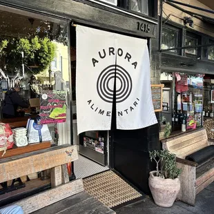a man sitting on a bench in front of a store