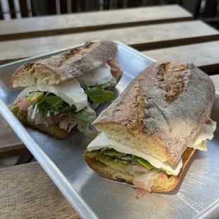 Meat sandwich: prosciutto crudo, basil pesto, red onion, Basque peppers, pickled turnips, arugula, mozzarella