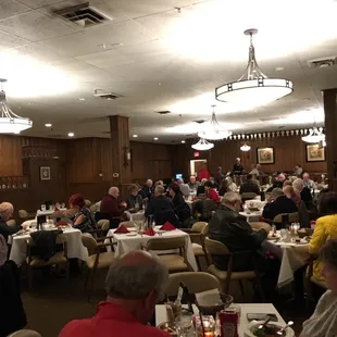 people sitting at tables in a restaurant