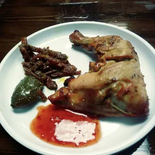 Chicken quarter, green mango and pickled carrots.