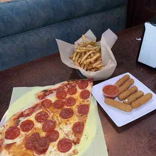 Two slices of pepperoni pizza French fries  Mozzarella sticks