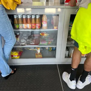 two people standing in front of a refridgerator