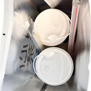 two coffee cups in a plastic bag