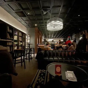 people sitting at tables in a restaurant