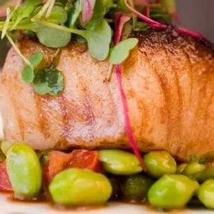 a piece of fish with vegetables