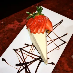 a piece of cheesecake with strawberries on top