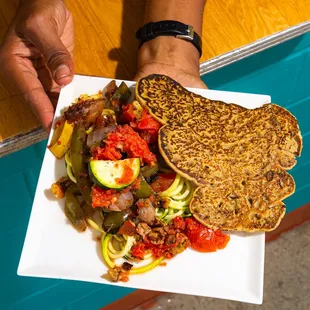 a person holding a plate of food