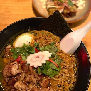 a bowl of ramen and a plate of salad