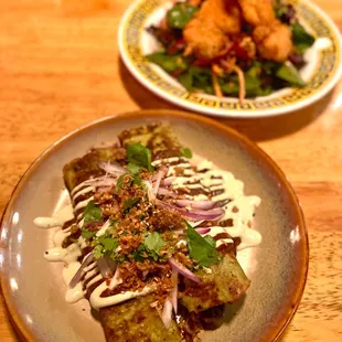 two plates of food on a wooden table