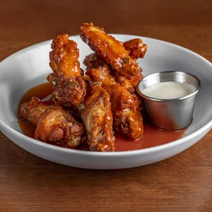 a plate of chicken wings with sauce