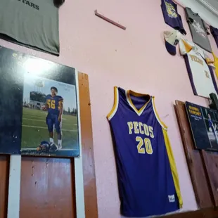 a basketball jersey hanging on a wall