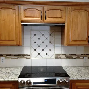  a kitchen with wood cabinets and granite countertops