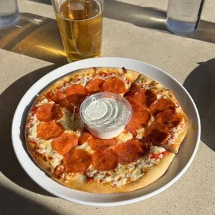 Pepperoni pizza and beer on the patio