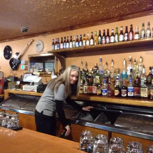 a woman behind the bar
