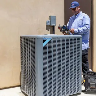 All Climate Air service technician checking coolant levels.